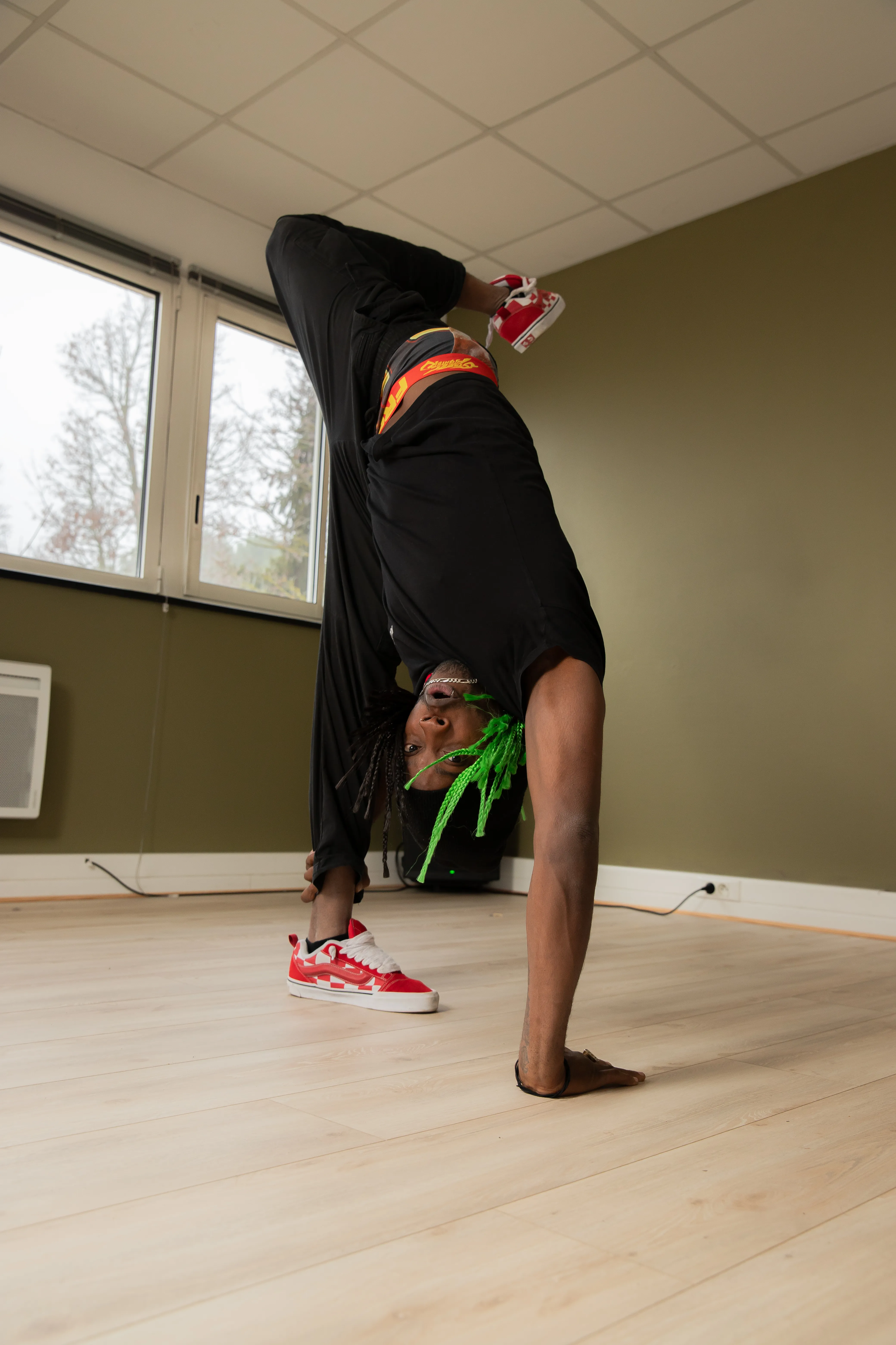 Julee-One en figure de breaking inversée, au sol, en intérieur